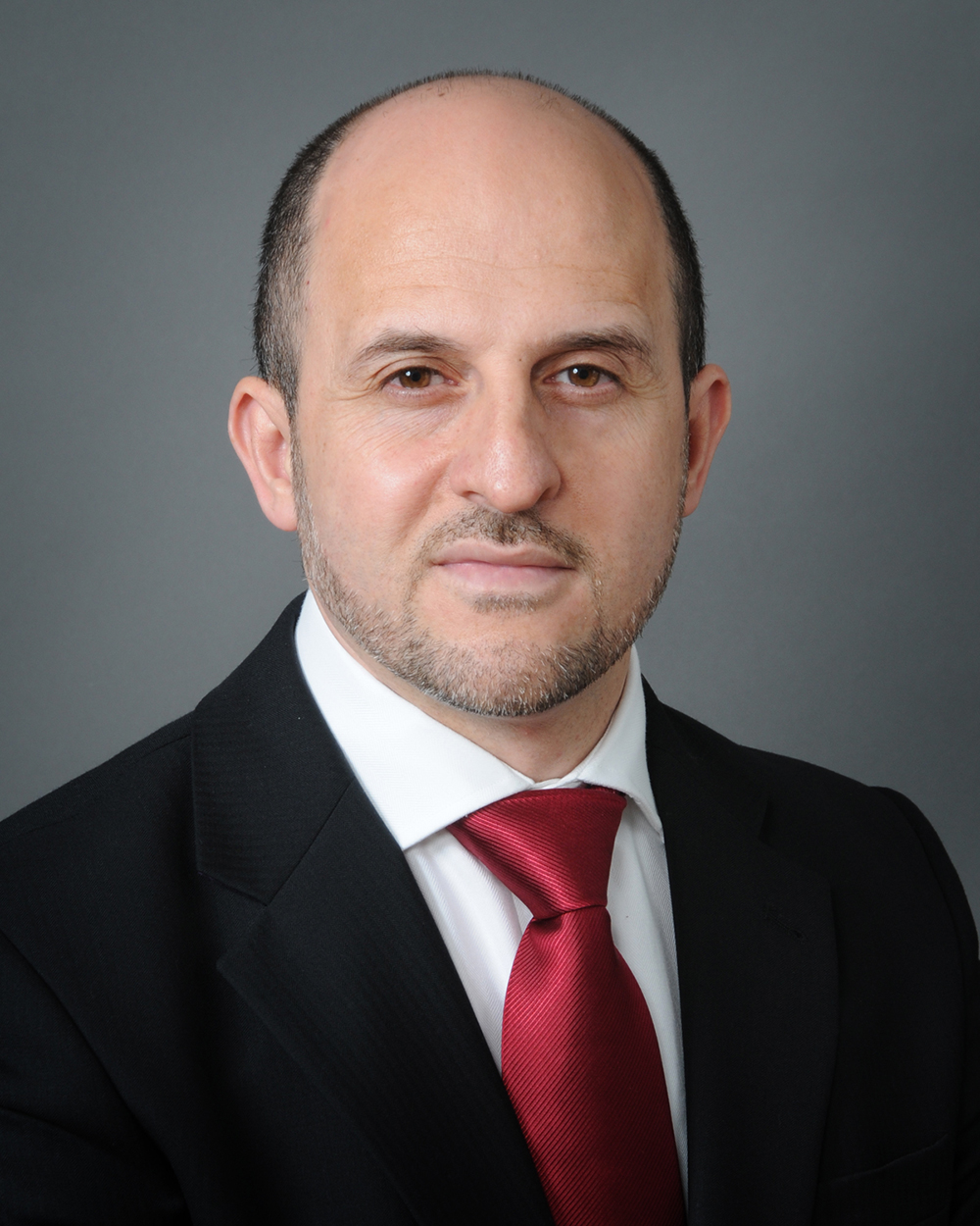 Portrait photo of Dr Arafat Madi Shoukri, wearing a suit.