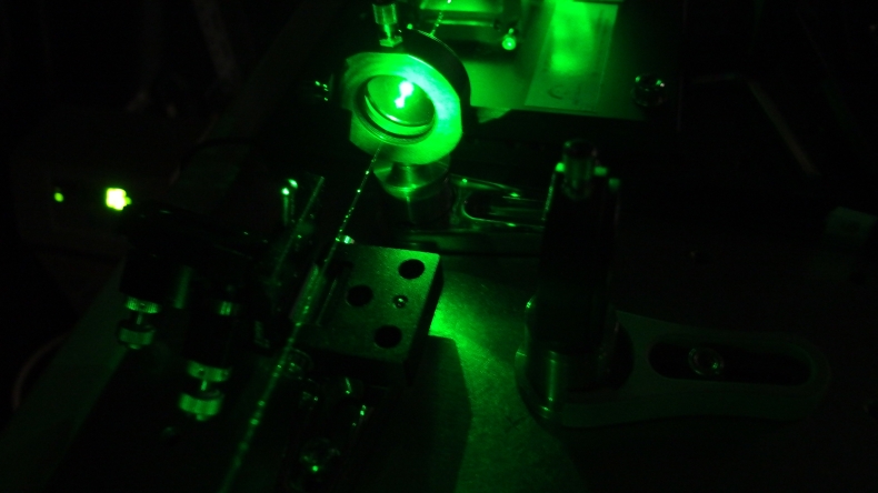 A pale green contraption on a black background